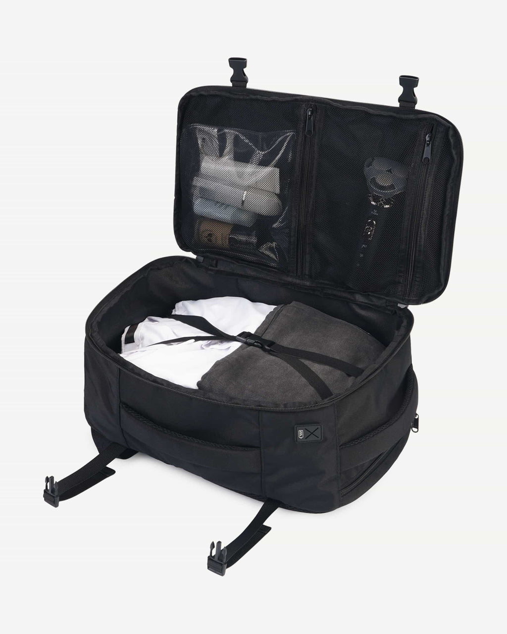 Black carry-on travel backpack open with packed interior