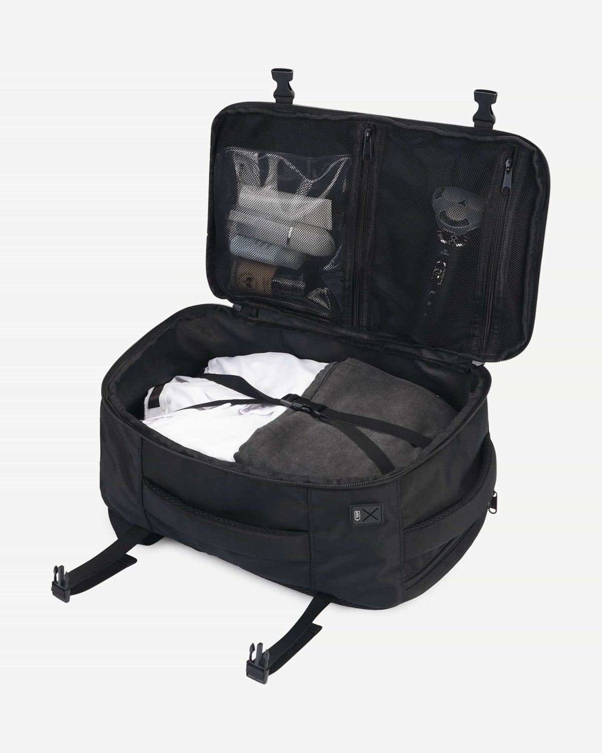 Black carry-on travel backpack open with packed interior