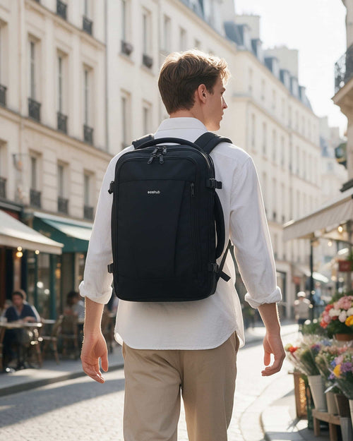 Traveler wearing a black carry-on travel backpack