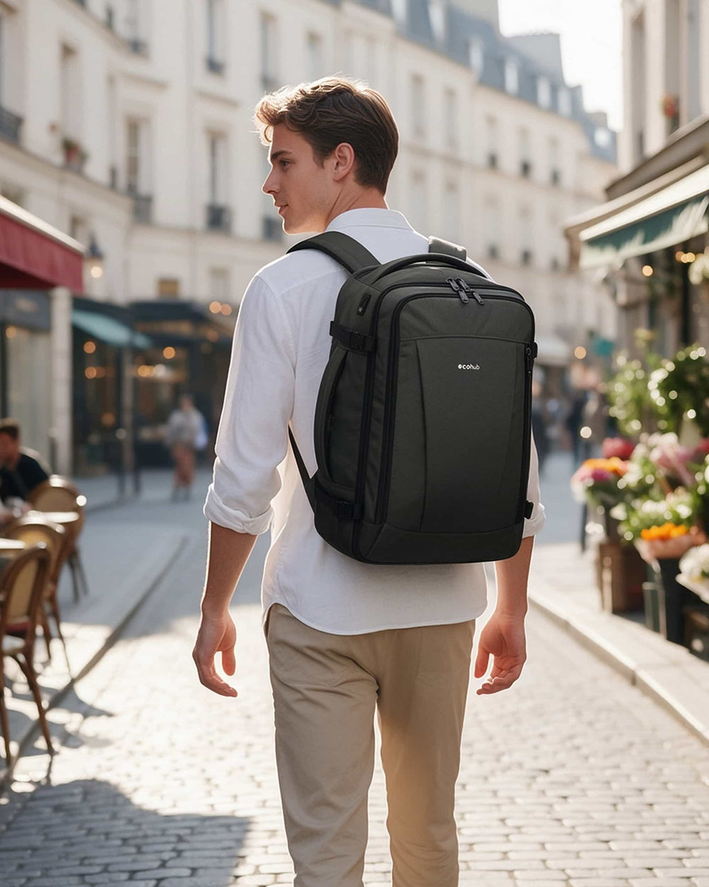 Traveler wearing a dark gray carry-on travel backpack