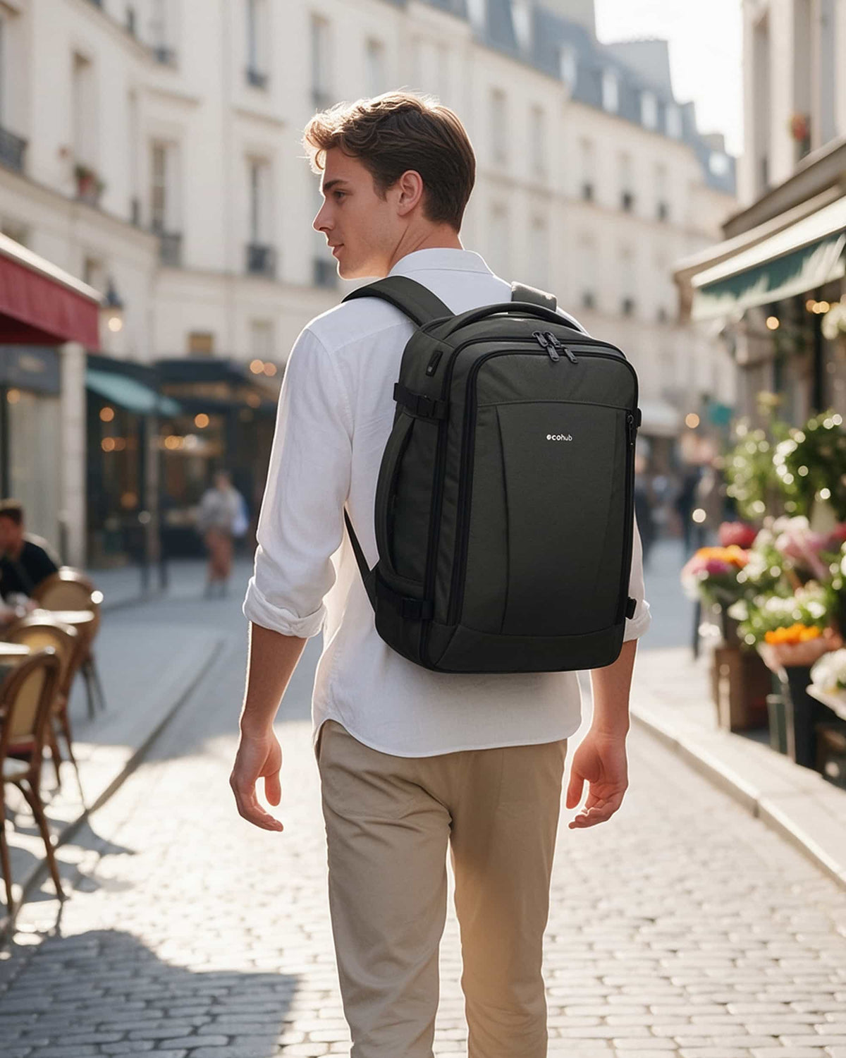 Traveler wearing a dark gray carry-on travel backpack